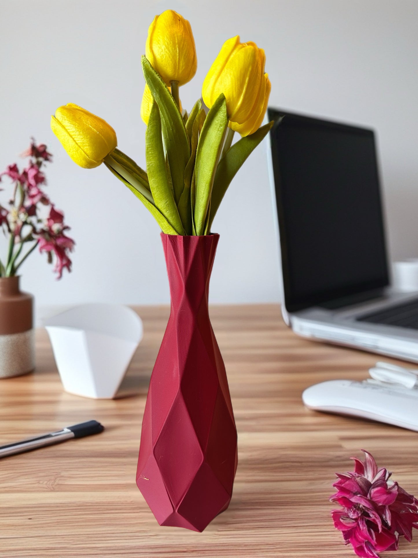 Modern desk setup featuring geometric 3D printed vase with flowers