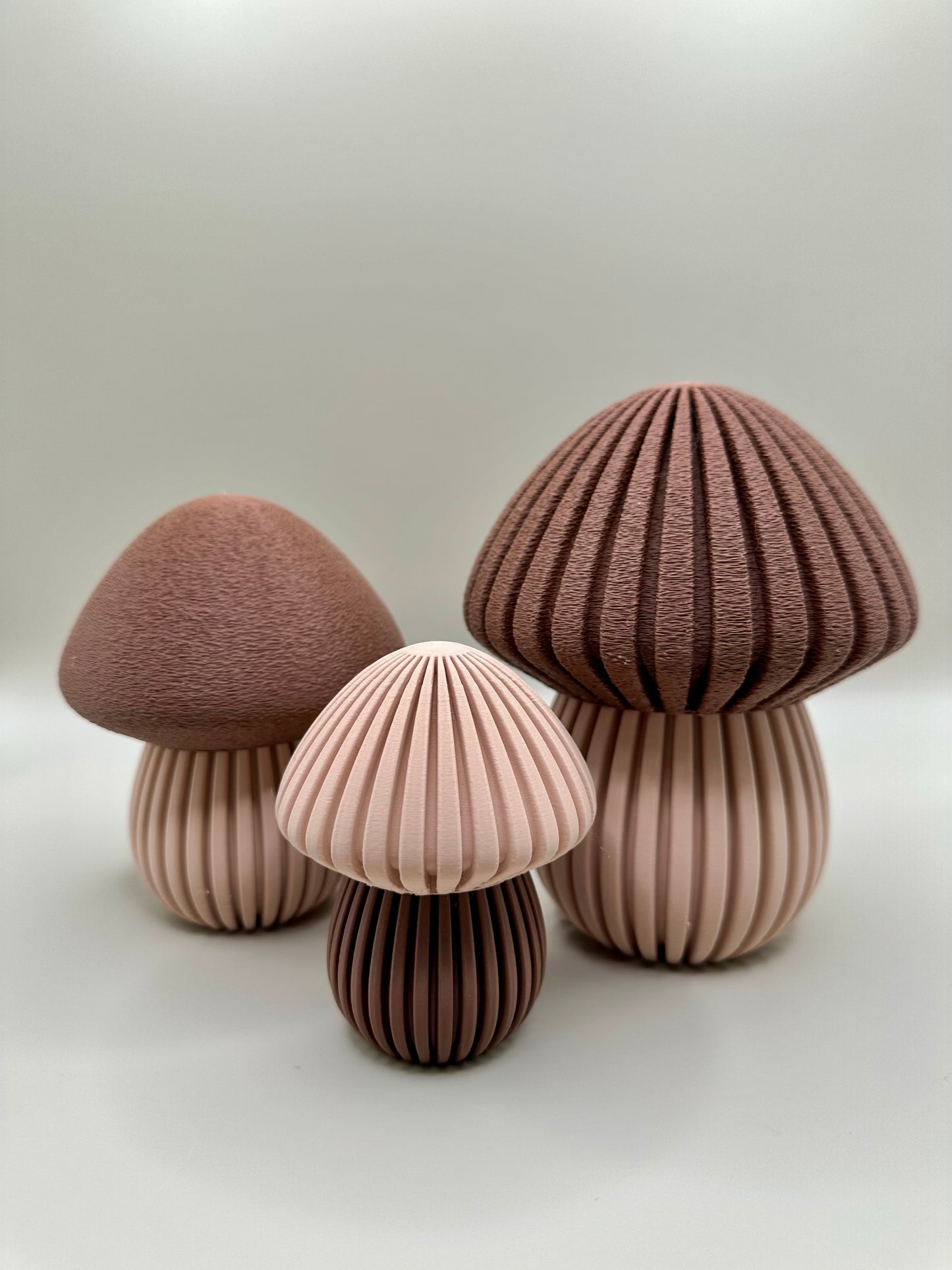 Decorative mushroom pods in red, beige, and brown tones
