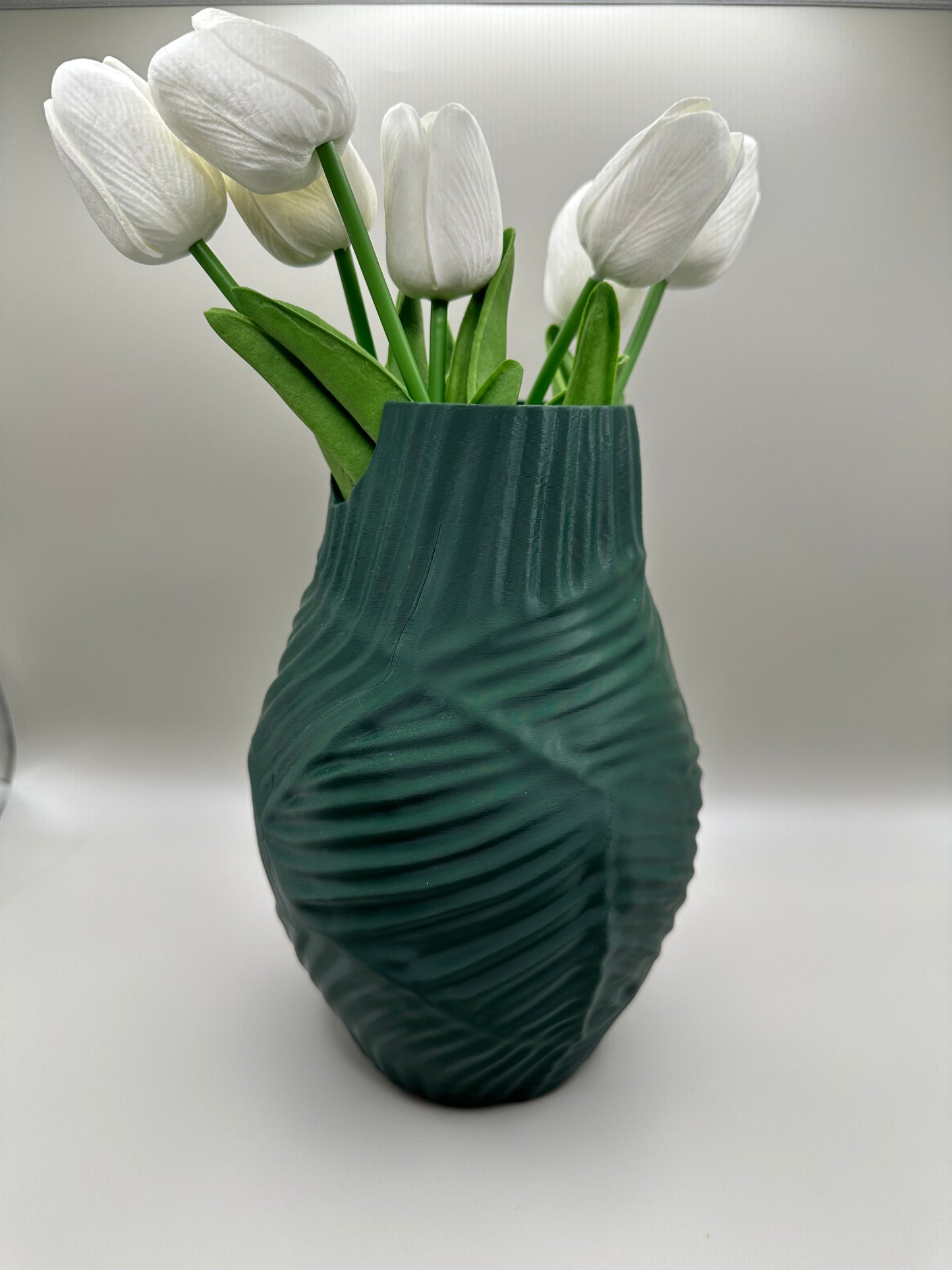 3D printed vase with twisted ridged surface, styled with tulips
