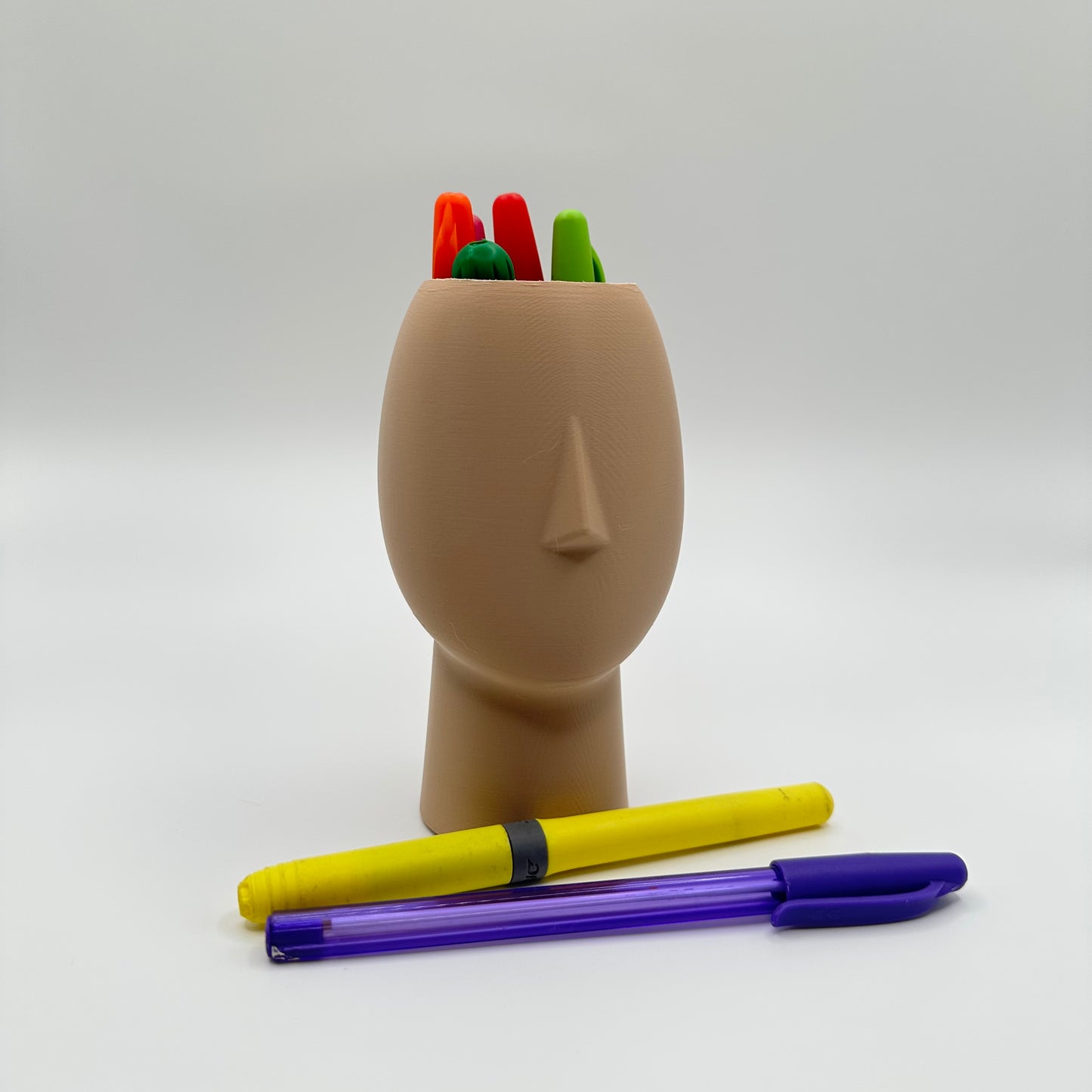 Sculptural head-shaped container for creative desk spaces