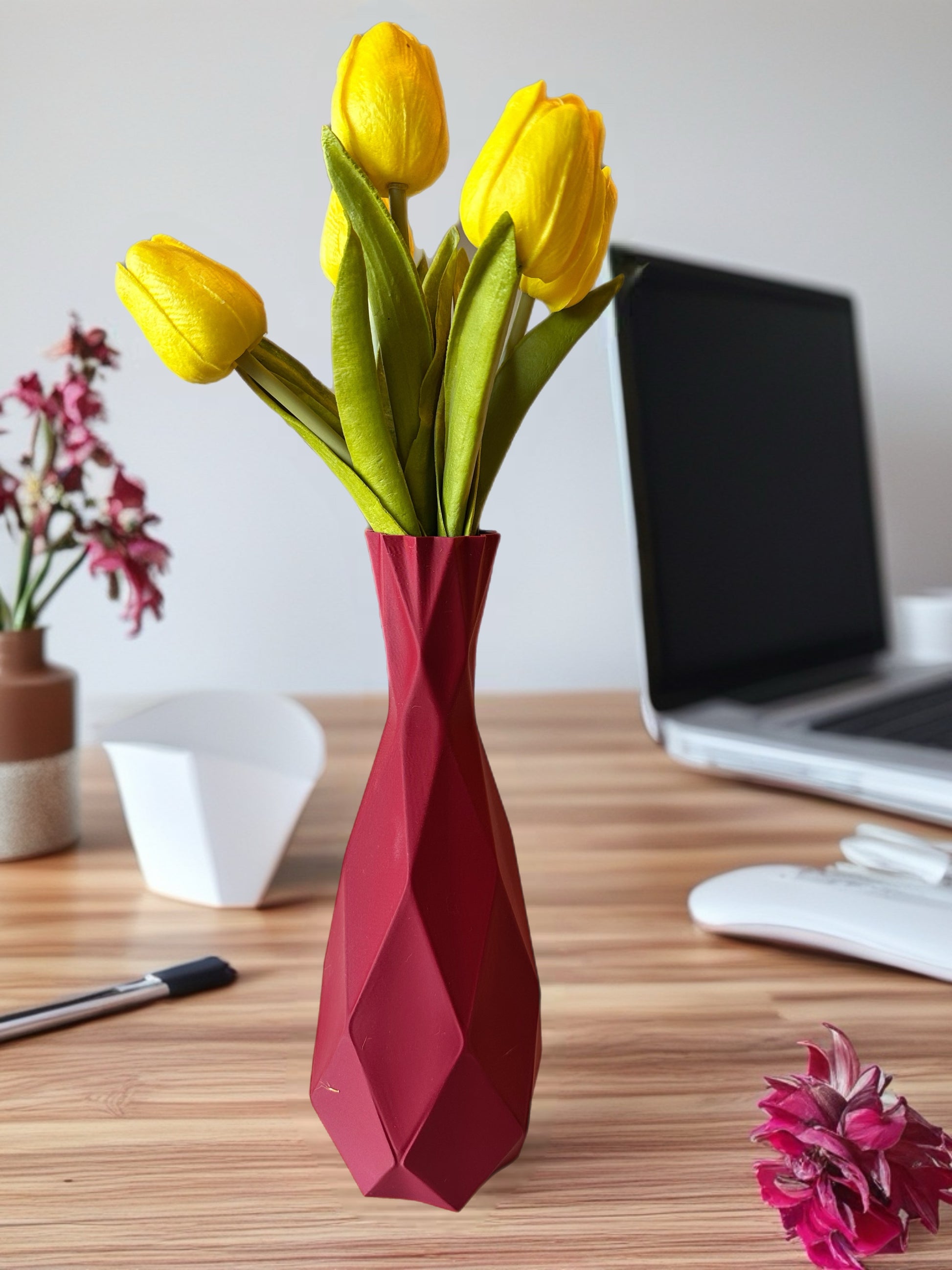 Modern desk setup featuring geometric 3D printed vase with flowers