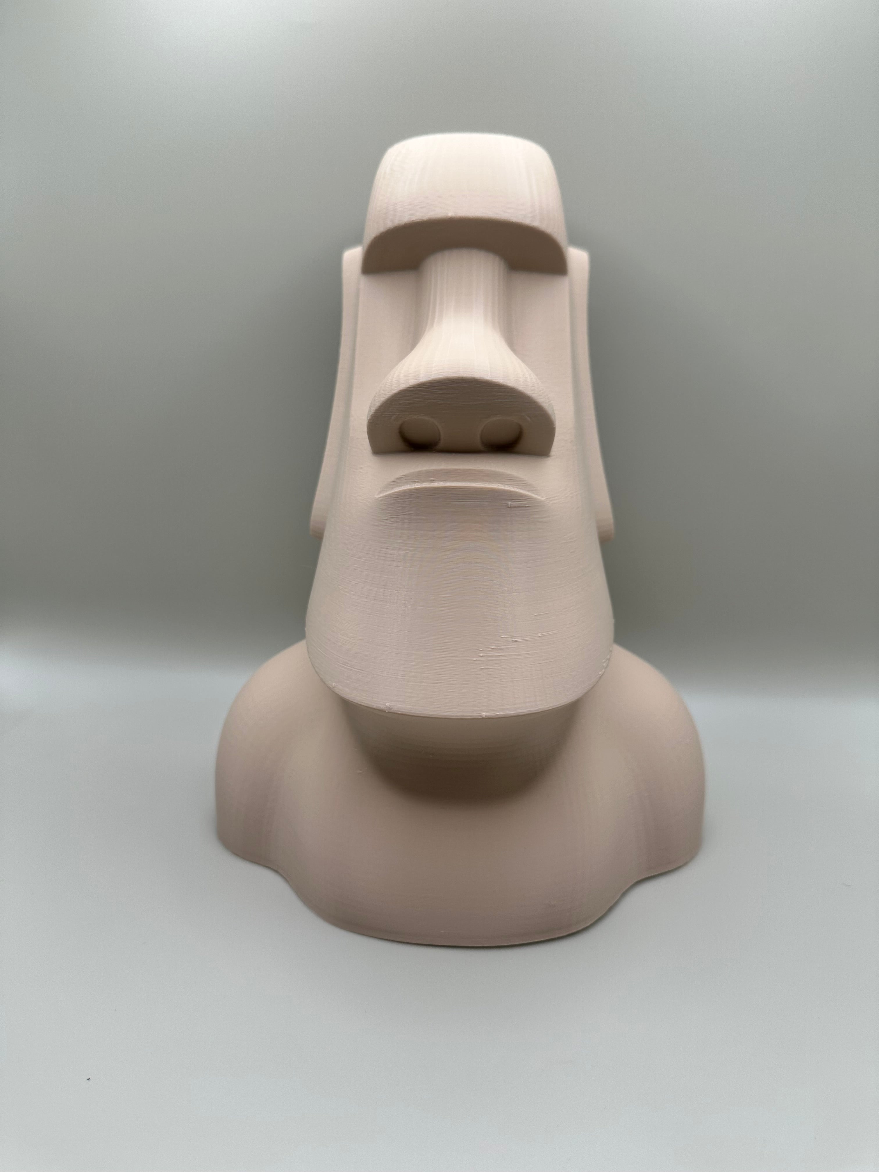 Moai statue coin bank in soft beige, 3D printed with minimalist curves by Pilu Studio.
