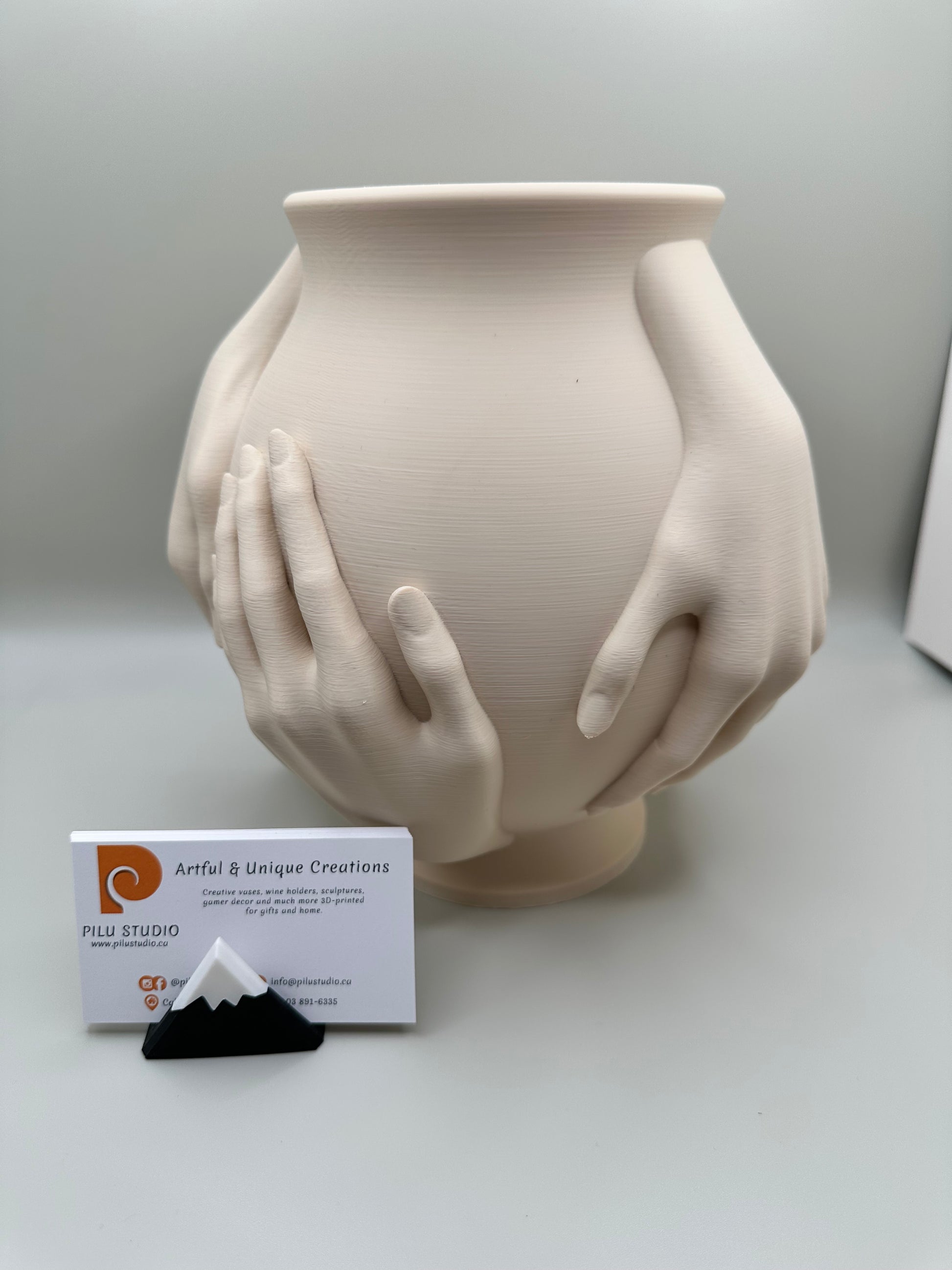 3D printed vase embraced by sculptural hands in minimalist style