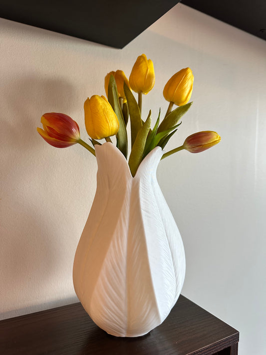 3D printed vase with leaf-inspired design styled with tulips on a shelf