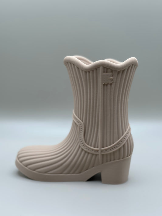 3D printed mini boot in beige used as a flower vase or pen holder