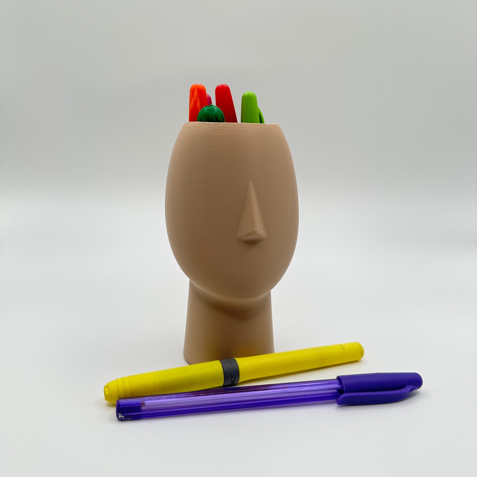 Sculptural head-shaped container for creative desk spaces