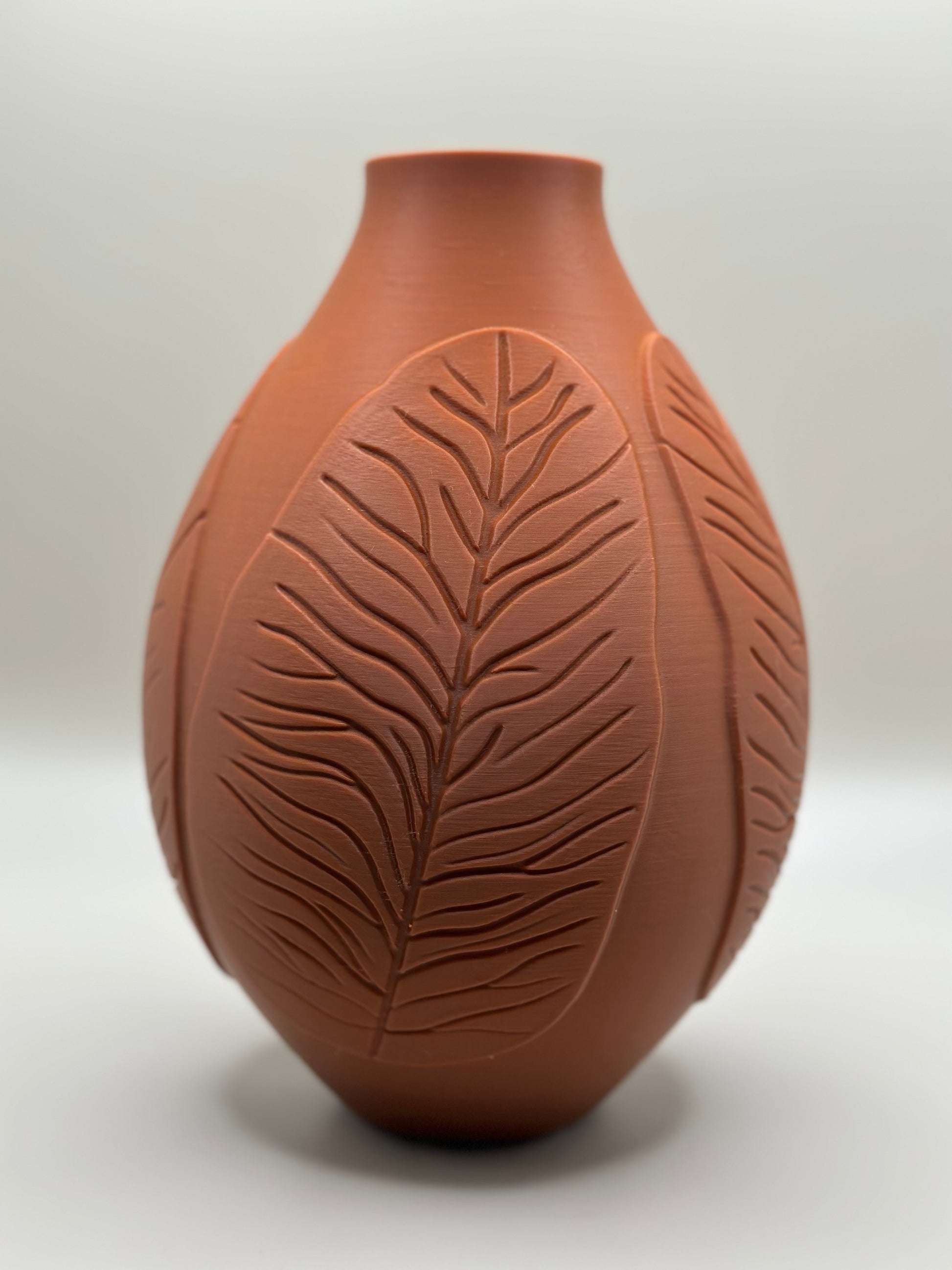 3D printed vase with raised leaf pattern in terracotta color