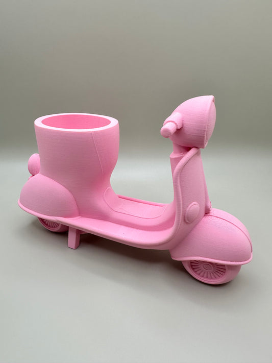 3D printed scooter-shaped holder ideal for succulents or desk organization with a playful touch.
